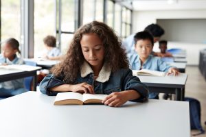 School child reading experiencing lexism